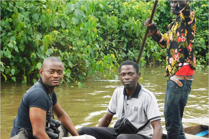 AfriBiRds monitoring campaign with teammates on a river in Nigeria.